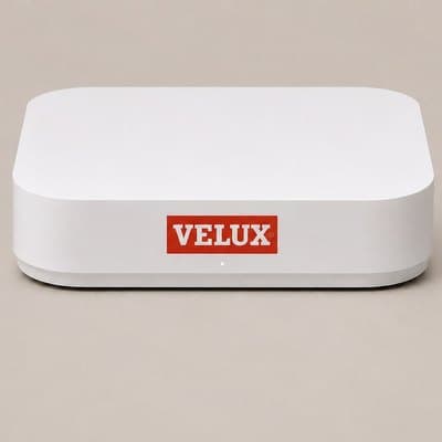 The SmartClimate hub, a low white box with the VELUX logo on the front and a single status light beneath it.