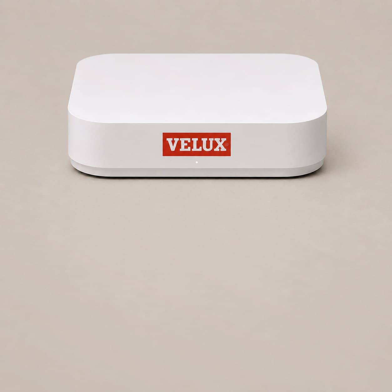 The SmartClimate hub, a low white box with the VELUX logo on the front and a single status light beneath it.