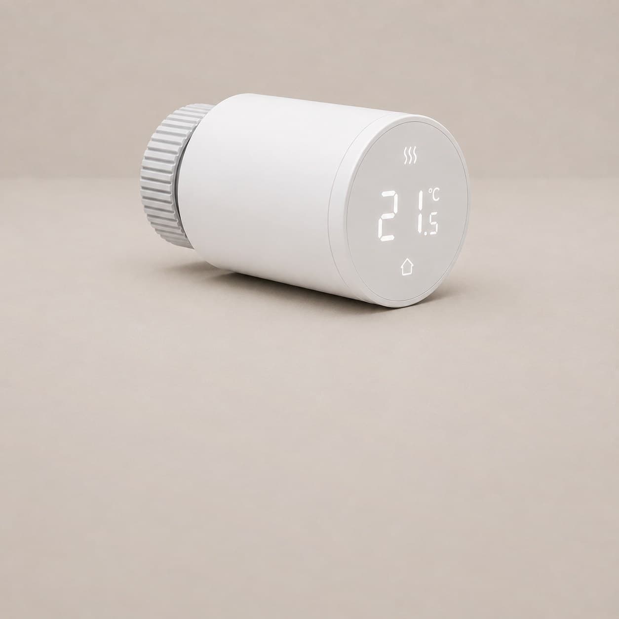 A smart radiator thermostat, a white cylinder with a ridged collar, its face reading twenty one and a half degrees.